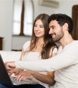 Couple looking at laptop_265x300
